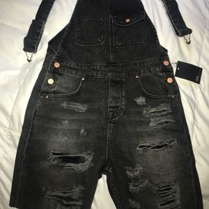 overall shorts with rips on thigh